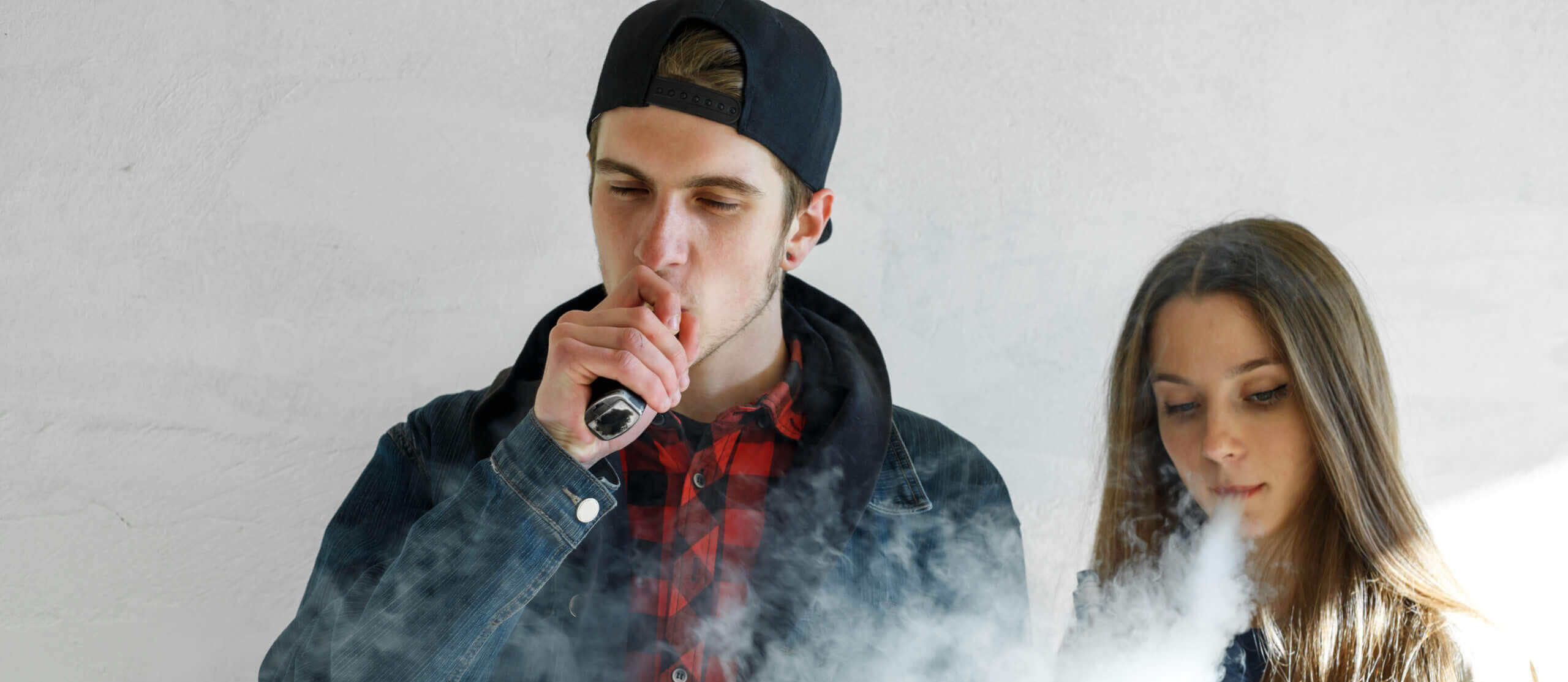 Youth Vaping. Teenage Boy and Girl Vaping.
